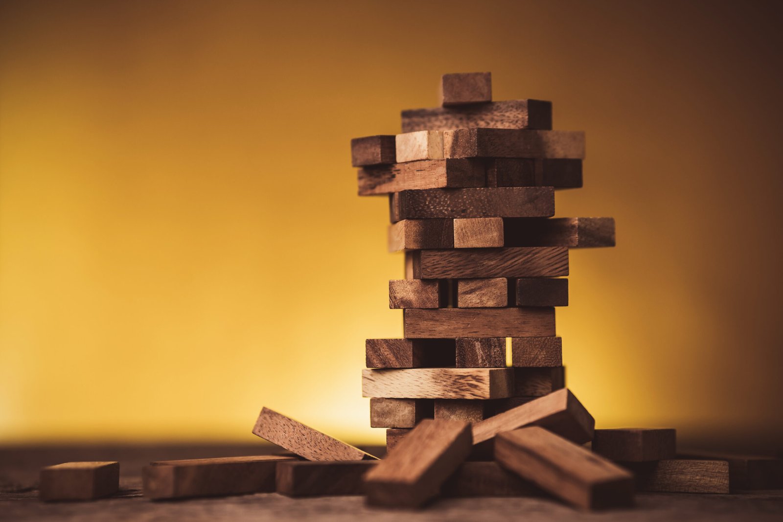 stack of wooden block piece with yellow background